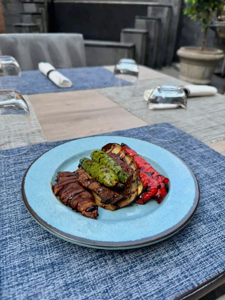 Grilled zucchini, eggplant, and red peppers drizzled with balsamic glaze.